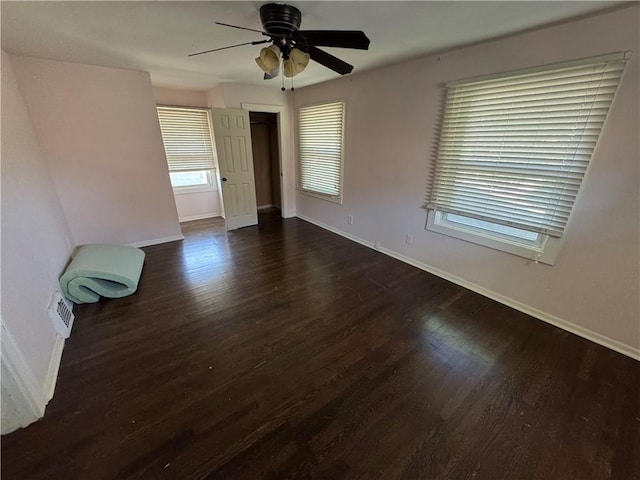 5647 Wayne Ave, Kansas City, MO 64110 - spare room with a ceiling fan and dark wood finished floors