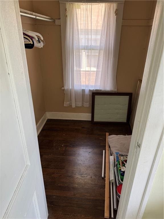 5647 Wayne Ave, Kansas City, MO 64110 - unfurnished bedroom featuring wood finished floors and baseboards