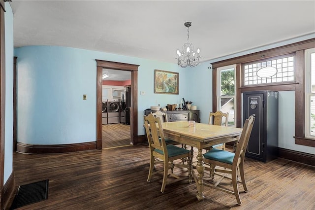 519 S Lincoln Ave, Chanute, KS 66720 - dining space featuring washing machine and clothes dryer, a chandelier, and wood finished floors
