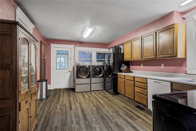 519 S Lincoln Ave, Chanute, KS 66720 - washroom with separate washer and dryer and dark wood-style floors