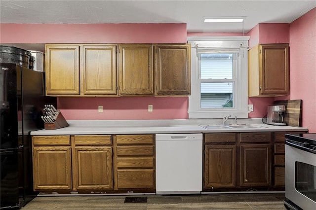 519 S Lincoln Ave, Chanute, KS 66720 - kitchen featuring dishwasher, light countertops, stainless steel electric range oven, and freestanding refrigerator