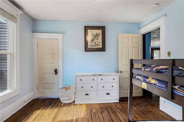 519 S Lincoln Ave, Chanute, KS 66720 - bedroom featuring dark wood-type flooring and multiple windows