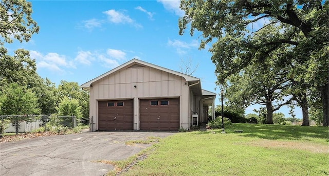 561 SW County Road O, Holden, MO 64040 - view of front of house featuring board and batten siding, driveway, and an attached garage