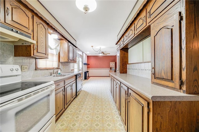 561 SW County Road O, Holden, MO 64040 - kitchen featuring white electric range, light countertops, tasteful backsplash, and brown cabinets
