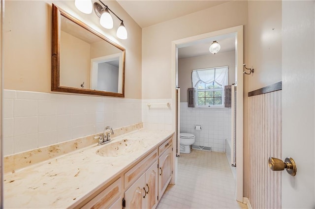 561 SW County Road O, Holden, MO 64040 - bathroom with tile walls, vanity, a wainscoted wall, and tile patterned floors