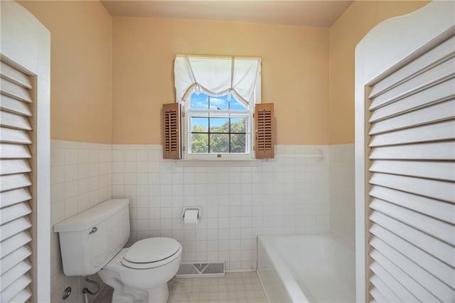561 SW County Road O, Holden, MO 64040 - full bath featuring tile walls, a bath, and a wainscoted wall