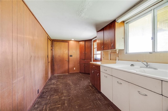 561 SW County Road O, Holden, MO 64040 - kitchen featuring wooden walls, light countertops, and dark flooring