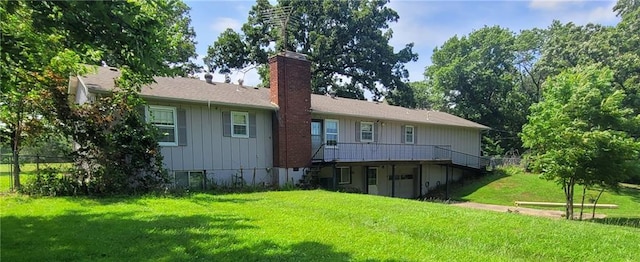 561 SW County Road O, Holden, MO 64040 - back of property with a yard, a chimney, a deck, and board and batten siding