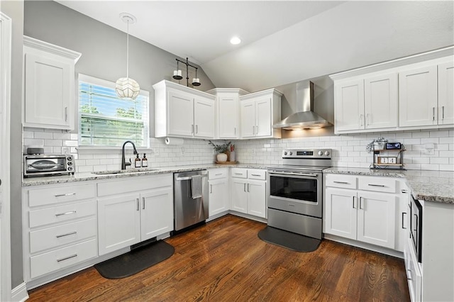 16728 Ruby Way, Basehor, KS 66007 - kitchen featuring appliances with stainless steel finishes, lofted ceiling, wall chimney range hood, white cabinets, and decorative backsplash