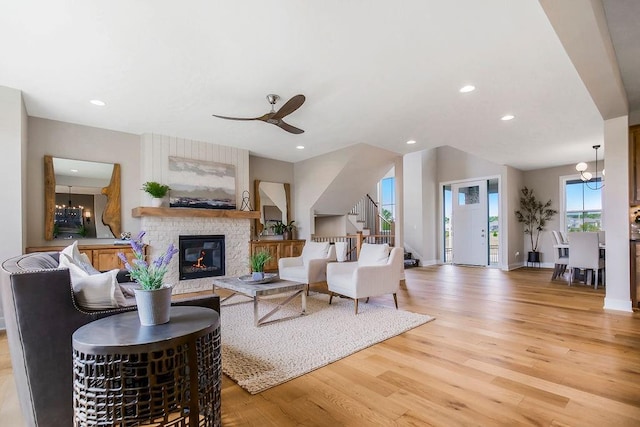 2416 W 177th St, Overland Park, KS 66085 - living area featuring stairway, a stone fireplace, light wood-style floors, a chandelier, and recessed lighting