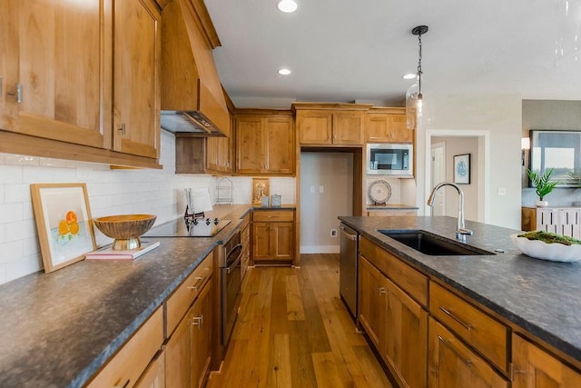 2416 W 177th St, Overland Park, KS 66085 - kitchen with stainless steel appliances, brown cabinets, dark wood-style floors, tasteful backsplash, and decorative light fixtures