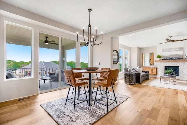 2416 W 177th St, Overland Park, KS 66085 - dining space featuring ceiling fan, healthy amount of natural light, light wood-type flooring, a glass covered fireplace, and recessed lighting