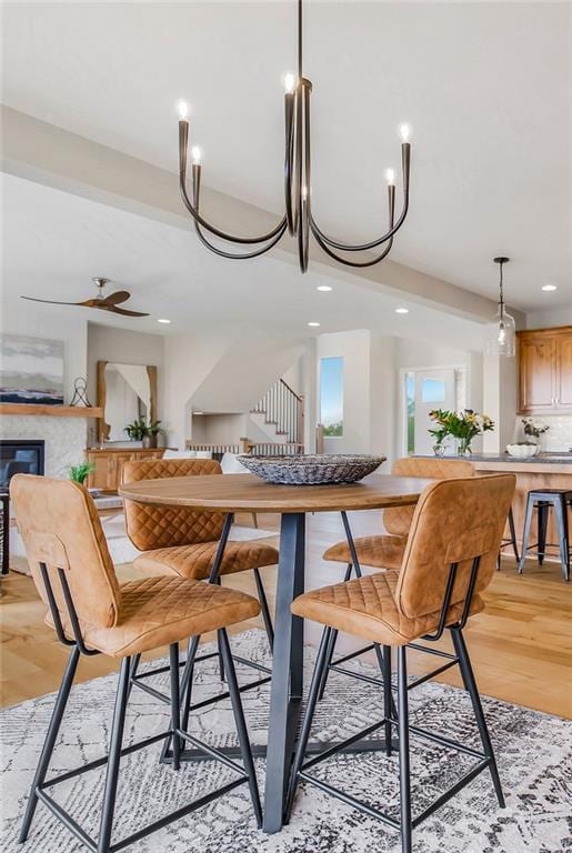 2416 W 177th St, Overland Park, KS 66085 - dining room with recessed lighting, light wood-style floors, a glass covered fireplace, and a ceiling fan