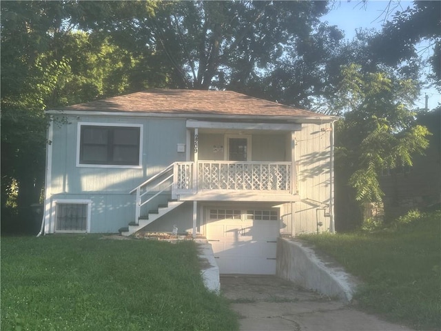 2209 E 72nd St, Kansas City, MO 64132 - view of front of property featuring an attached garage, concrete driveway, stairs, a front lawn, and a porch