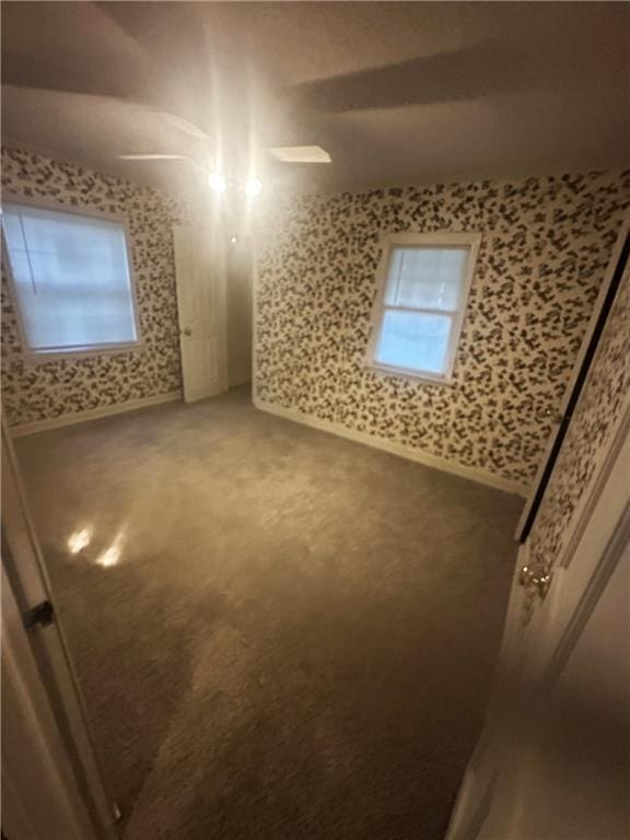 2209 E 72nd St, Kansas City, MO 64132 - spare room featuring carpet and wallpapered walls