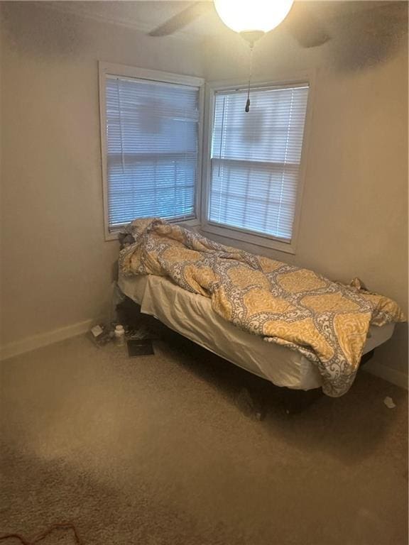 2209 E 72nd St, Kansas City, MO 64132 - carpeted bedroom featuring baseboards and a ceiling fan