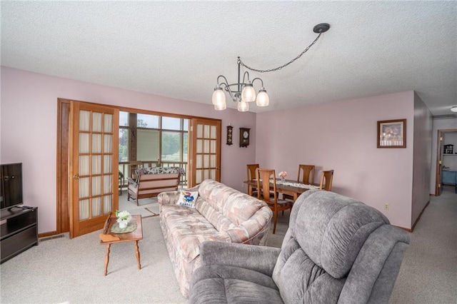 596 E 1732nd Rd, Baldwin City, KS 66006 - carpeted living room with a textured ceiling and a chandelier