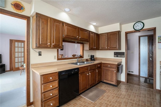 596 E 1732nd Rd, Baldwin City, KS 66006 - kitchen with black dishwasher, light countertops, and a textured ceiling