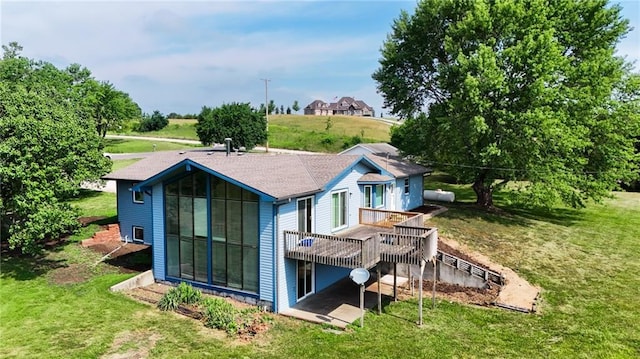 596 E 1732nd Rd, Baldwin City, KS 66006 - rear view of house featuring a wooden deck and a lawn