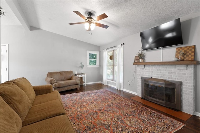 1101 Anderson St, Warrensburg, MO 64093 - living area featuring a ceiling fan, wood finished floors, lofted ceiling, a brick fireplace, and a textured ceiling