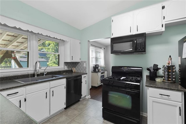 1101 Anderson St, Warrensburg, MO 64093 - kitchen featuring black appliances, dark countertops, healthy amount of natural light, and lofted ceiling