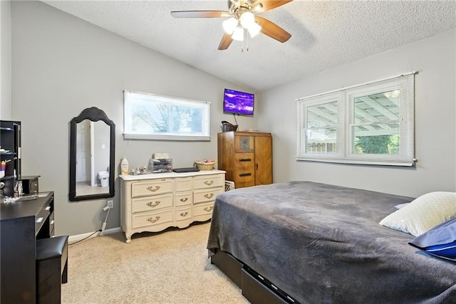 1101 Anderson St, Warrensburg, MO 64093 - bedroom with vaulted ceiling, light carpet, a textured ceiling, and a ceiling fan