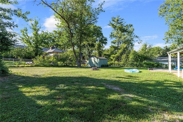 1101 Anderson St, Warrensburg, MO 64093 - view of yard featuring a storage unit and a patio