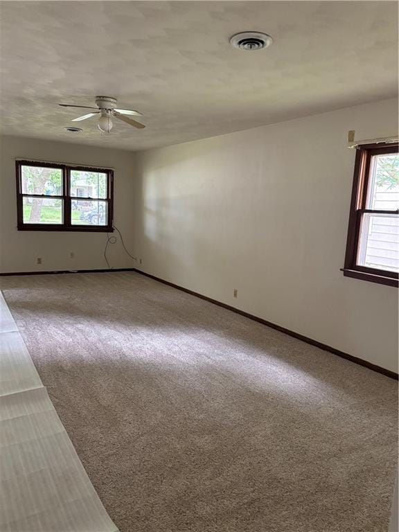 420 S Walnut St, Iola, KS 66749 - empty room featuring a ceiling fan and carpet floors