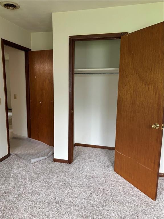 420 S Walnut St, Iola, KS 66749 - unfurnished bedroom featuring carpet floors and a closet