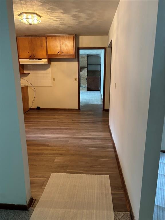420 S Walnut St, Iola, KS 66749 - hallway with baseboards and dark wood finished floors