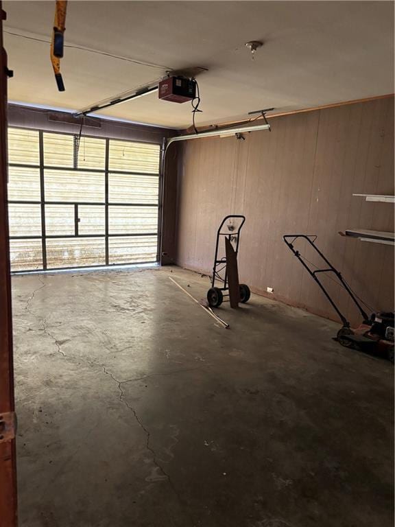 420 S Walnut St, Iola, KS 66749 - garage with a garage door opener and wooden walls
