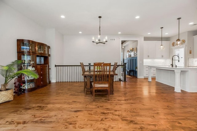 1034 SW Cheshire Dr, Lees Summit, MO 64083 - dining area with a chandelier, light wood finished floors, and recessed lighting