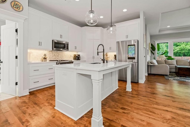 1034 SW Cheshire Dr, Lees Summit, MO 64083 - kitchen featuring appliances with stainless steel finishes, recessed lighting, light countertops, backsplash, and white cabinets