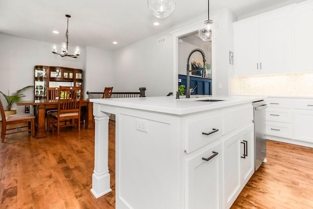 1034 SW Cheshire Dr, Lees Summit, MO 64083 - kitchen featuring dishwasher, a chandelier, light wood-style floors, recessed lighting, and light countertops