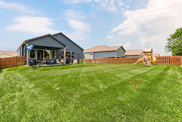 1034 SW Cheshire Dr, Lees Summit, MO 64083 - rear view of house featuring a playground, a fenced backyard, a patio, and ceiling fan