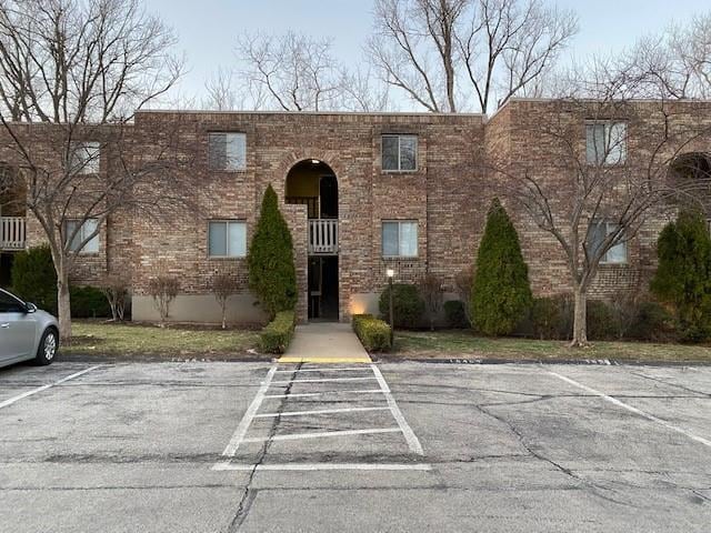1848 E 97th St Unit C & D, Kansas City, MO 64131 - view of front facade with uncovered parking and brick siding