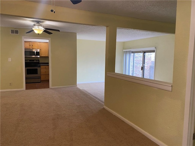 1848 E 97th St Unit C & D, Kansas City, MO 64131 - carpeted empty room featuring a ceiling fan and a textured ceiling