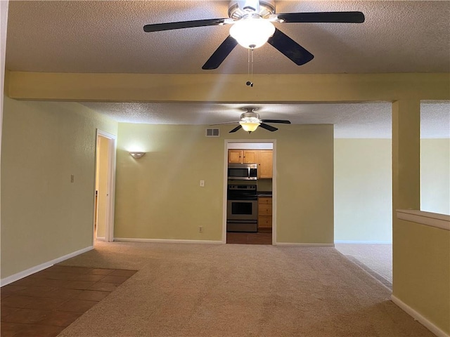 1848 E 97th St Unit C & D, Kansas City, MO 64131 - spare room with a textured ceiling, a ceiling fan, and carpet