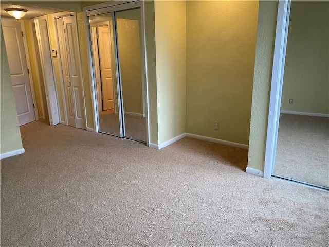 1848 E 97th St Unit C & D, Kansas City, MO 64131 - unfurnished bedroom featuring carpet flooring and two closets