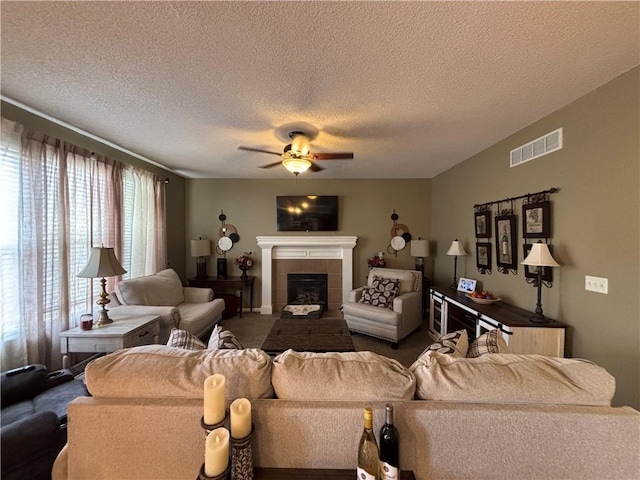 1840 W Fredrickson Cir, Olathe, KS 66061 - carpeted living area with ceiling fan, a tiled fireplace, and a textured ceiling