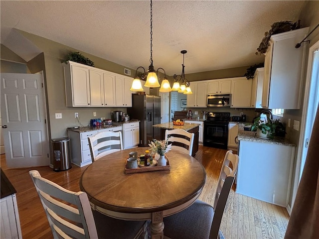 1840 W Fredrickson Cir, Olathe, KS 66061 - dining area with dark wood finished floors and a textured ceiling
