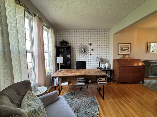 1840 W Fredrickson Cir, Olathe, KS 66061 - office area featuring wallpapered walls, a textured ceiling, wood finished floors, and an accent wall