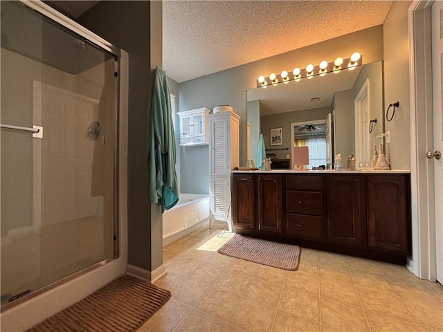 1840 W Fredrickson Cir, Olathe, KS 66061 - full bath featuring a stall shower, a garden tub, tile patterned floors, double vanity, and a textured ceiling
