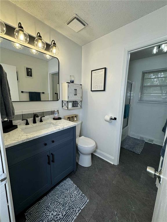 213 SW Palo Dr, Blue Springs, MO 64014 - full bath with an enclosed shower, vanity, and a textured ceiling
