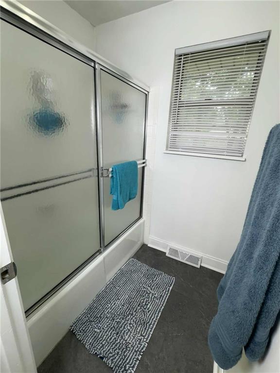 213 SW Palo Dr, Blue Springs, MO 64014 - full bathroom with bath / shower combo with glass door and baseboards