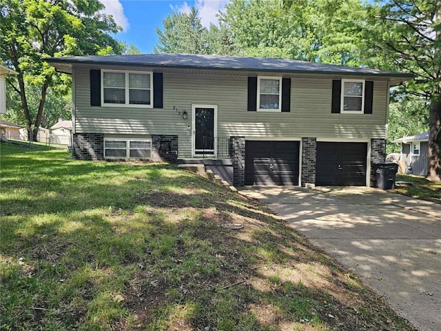 213 SW Palo Dr, Blue Springs, MO 64014 - raised ranch with a garage, concrete driveway, and a front lawn