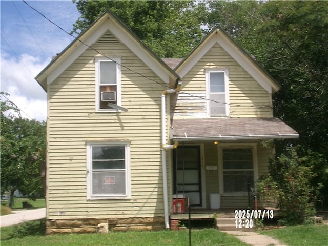 211 W Madison St, Yates Center, KS 66783 - view of front of property with a porch, a front yard, and cooling unit