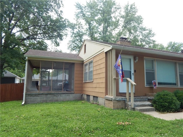 2031 Spruce St, Leavenworth, KS 66048 - view of front of house with a sunroom and a chimney