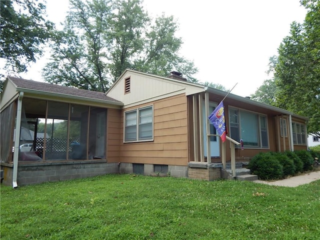 2031 Spruce St, Leavenworth, KS 66048 - view of front of property with a front lawn, a sunroom, a chimney, and roof with shingles