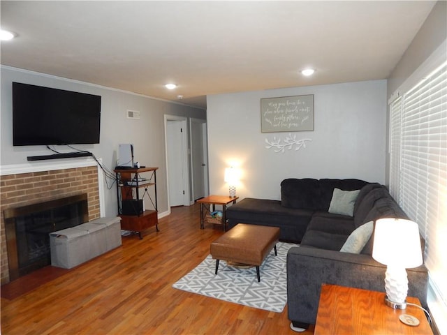 2031 Spruce St, Leavenworth, KS 66048 - living room with wood finished floors, a fireplace, recessed lighting, and ornamental molding